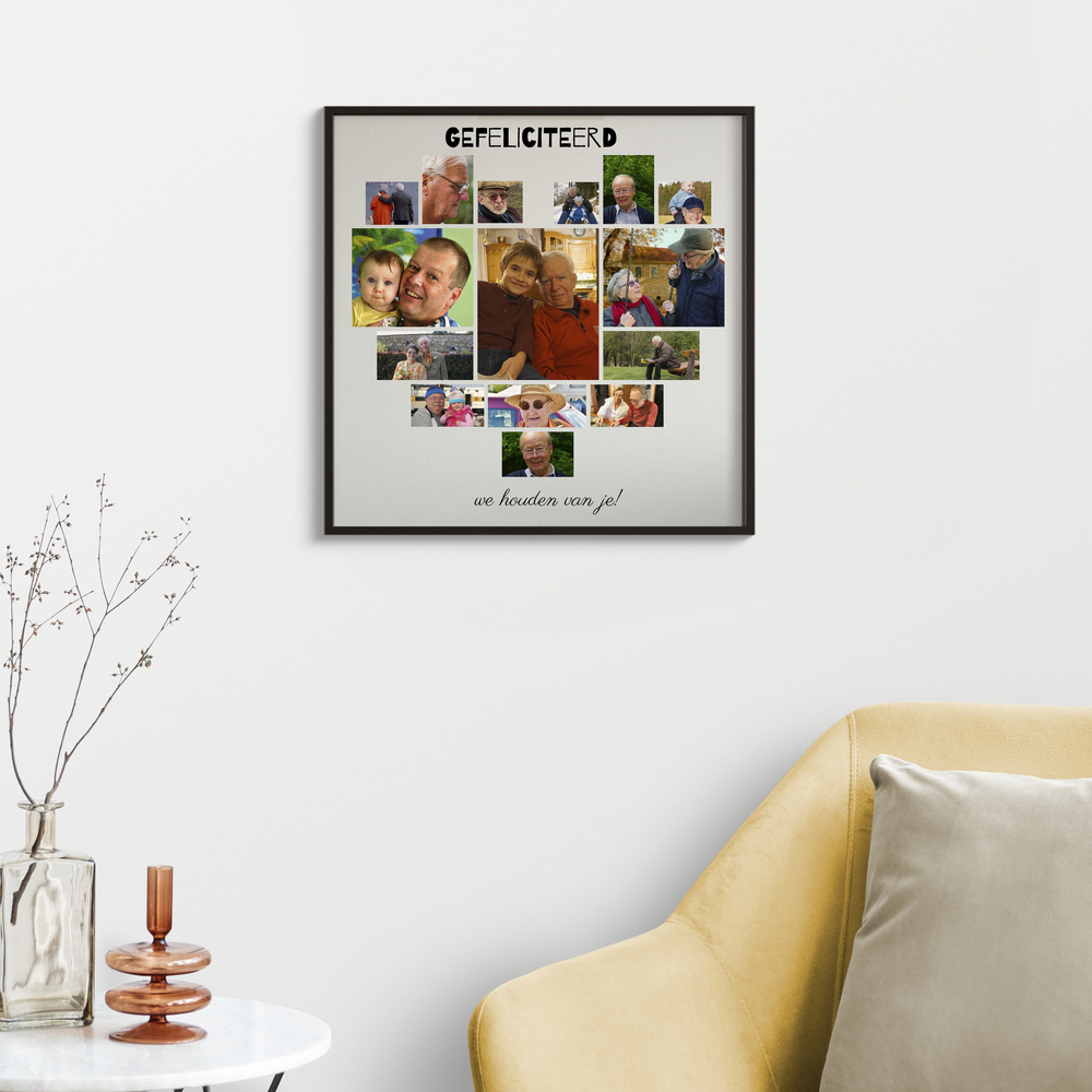 Fotocollage in hartvorm met verjaardagsgroet in een zwarte lijst aan de muur naast een gele fauteuil
